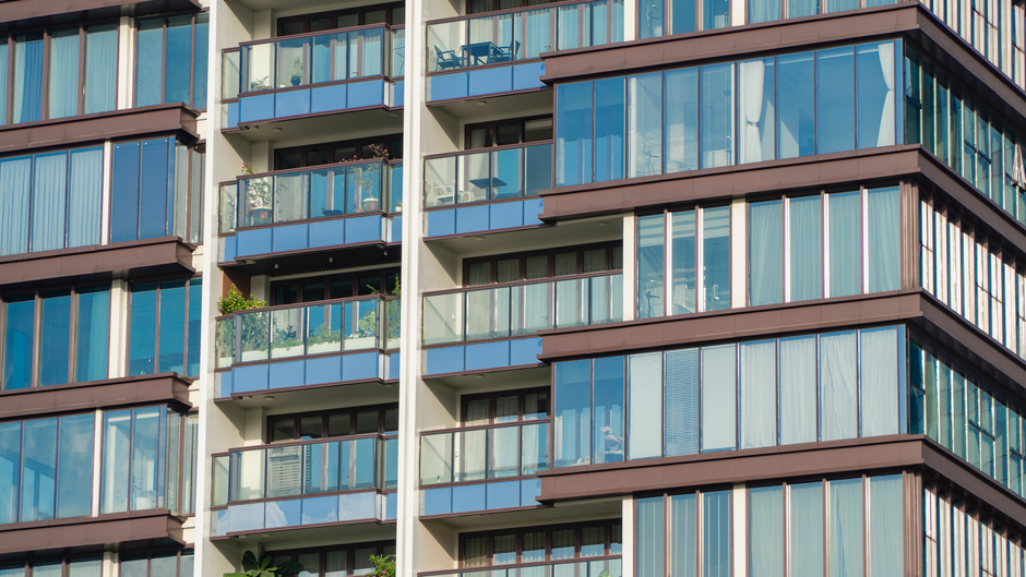 Close-up view of modern glass apartment facade with balconies in Manhattan