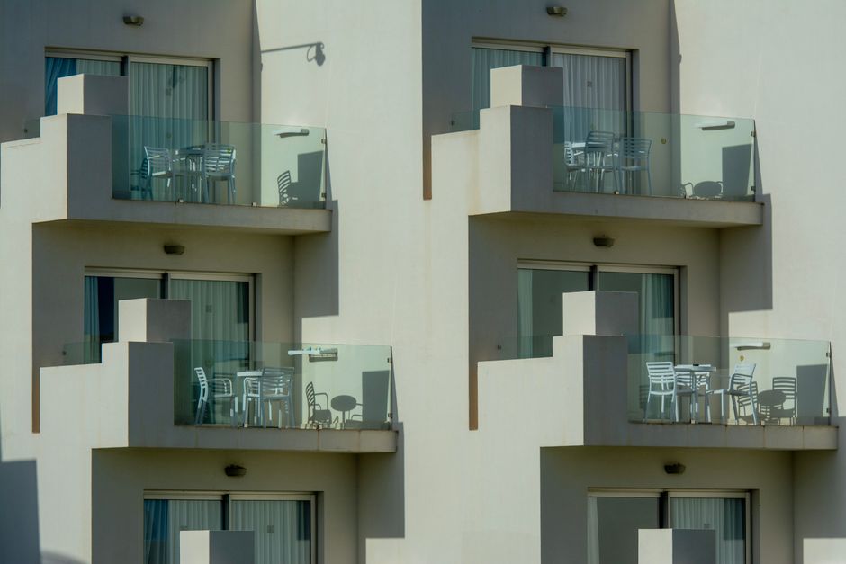 Architectural view of modern apartment balconies with sleek glass railings