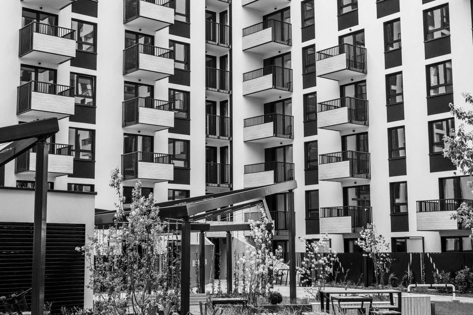 Contemporary urban apartment building with balconies and courtyard in Queens
